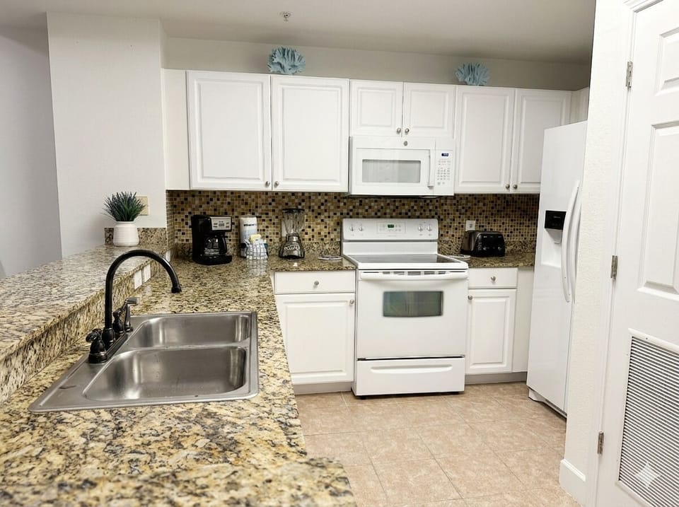 Full Kitchen with dishwasher, coffee makers, blender, everything you need. 