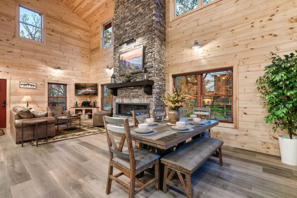 This inviting living and dining area combines rustic charm with modern amenities, creating the perfect space to unwind after a day of adventure.