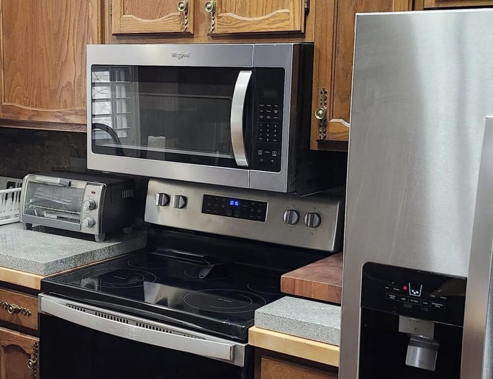 Toaster Oven, microwave, oven and refrigerator in the kitchen
