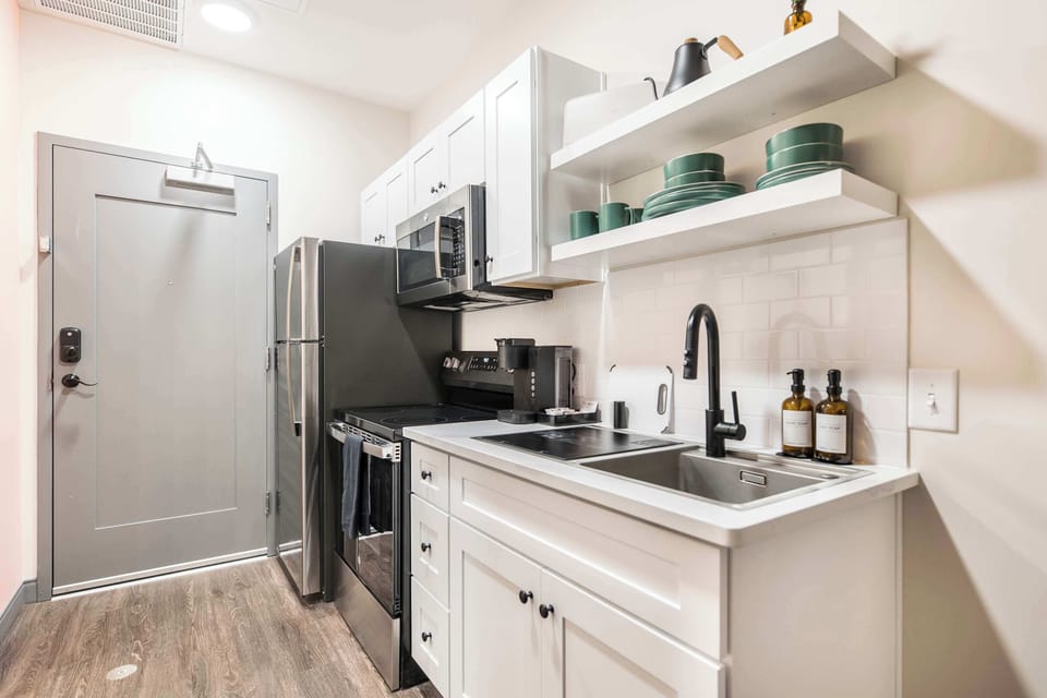 Cook with ease in a full kitchen featuring sleek stainless steel appliances, offering both style and functionality for your stay