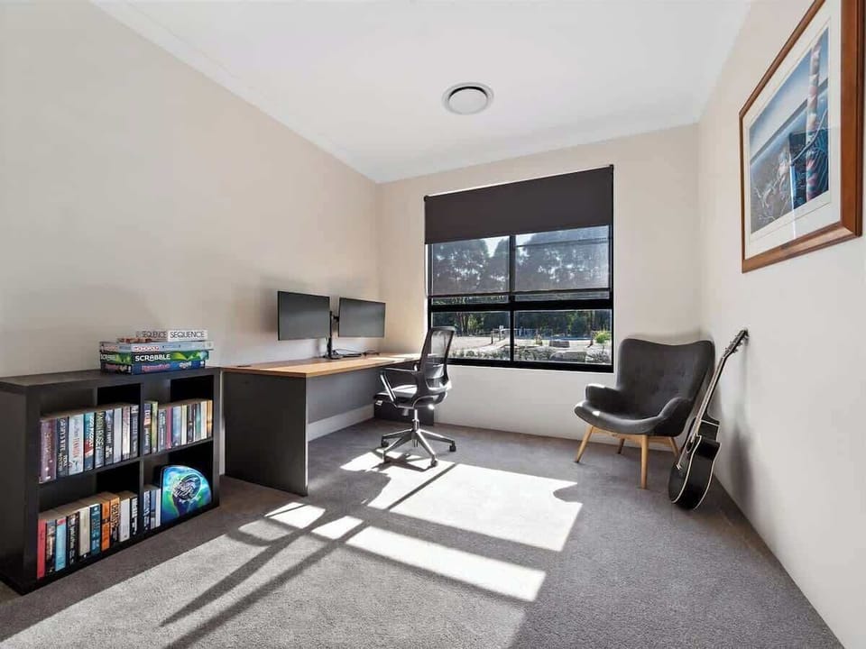A fully equipped work-from-home space with natural light and bushland views.