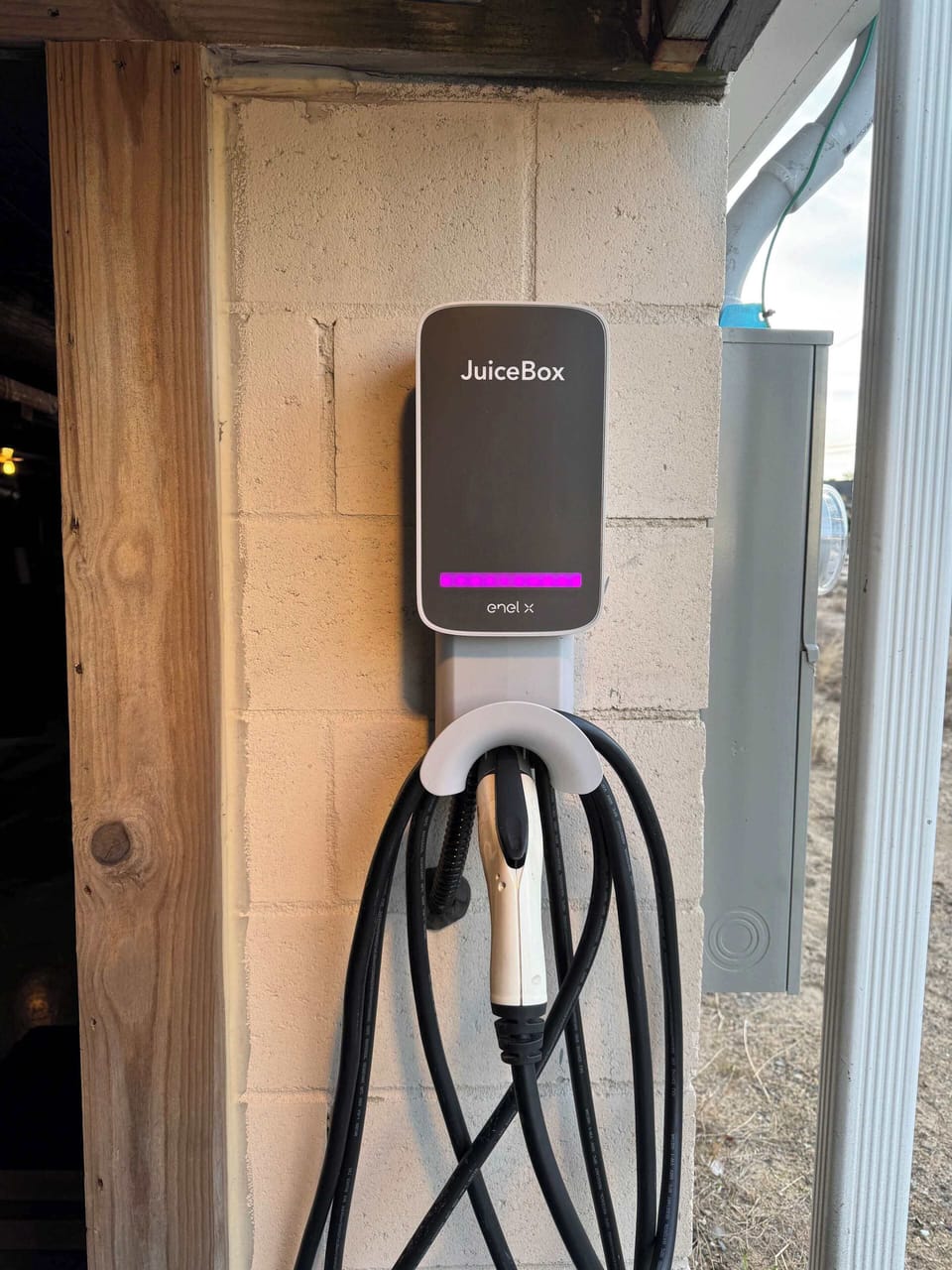 This home is equipped with a level 2 car charger. It's located under the deck right by the driveway