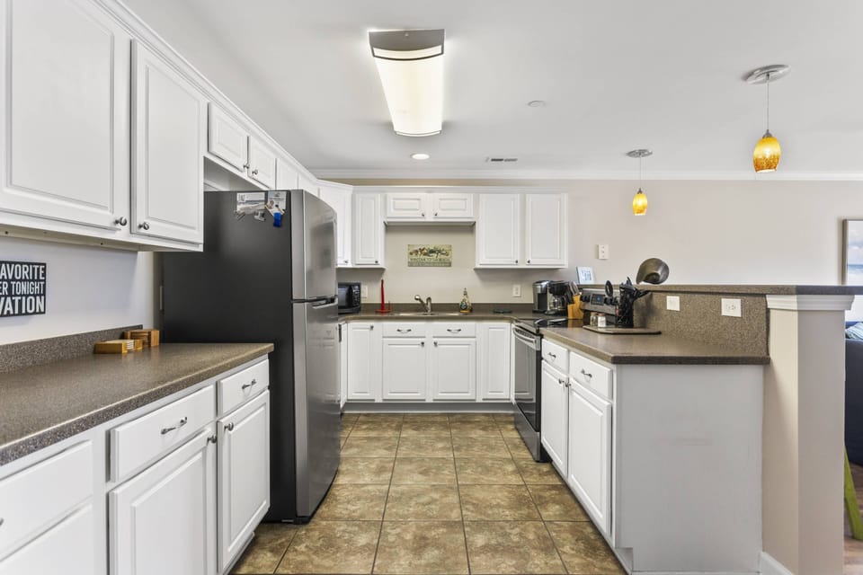 Spacious kitchen with stove, microwave, and refrigerator