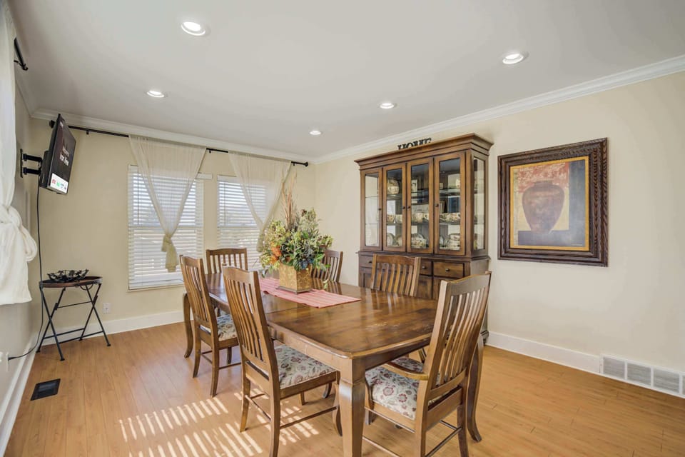 Elegant dining room with a spacious table, a beautiful china cabinet, and plenty of natural light for a warm and inviting atmosphere.




