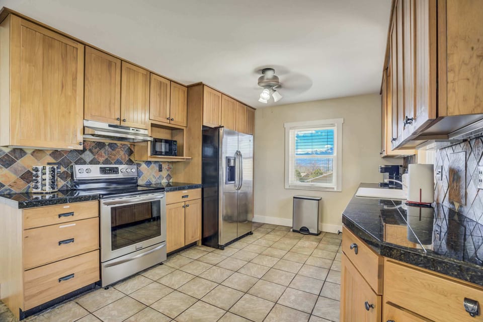 Fully equipped kitchen with modern appliances, ample counter space, and plenty of storage for a convenient cooking experience.




