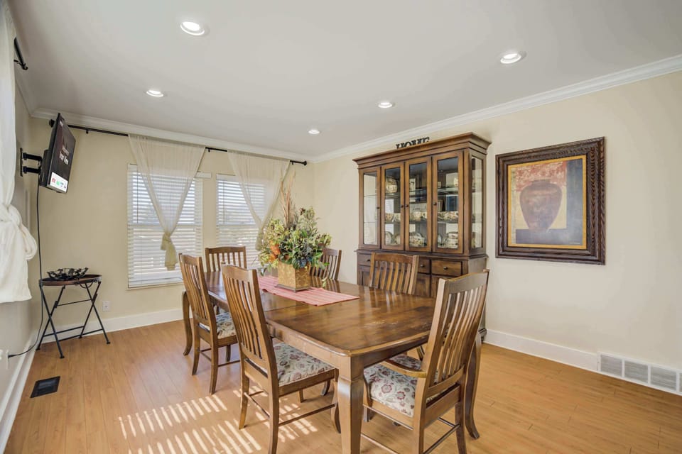 Elegant dining room with a spacious table, a beautiful china cabinet, and plenty of natural light for a warm and inviting atmosphere.




