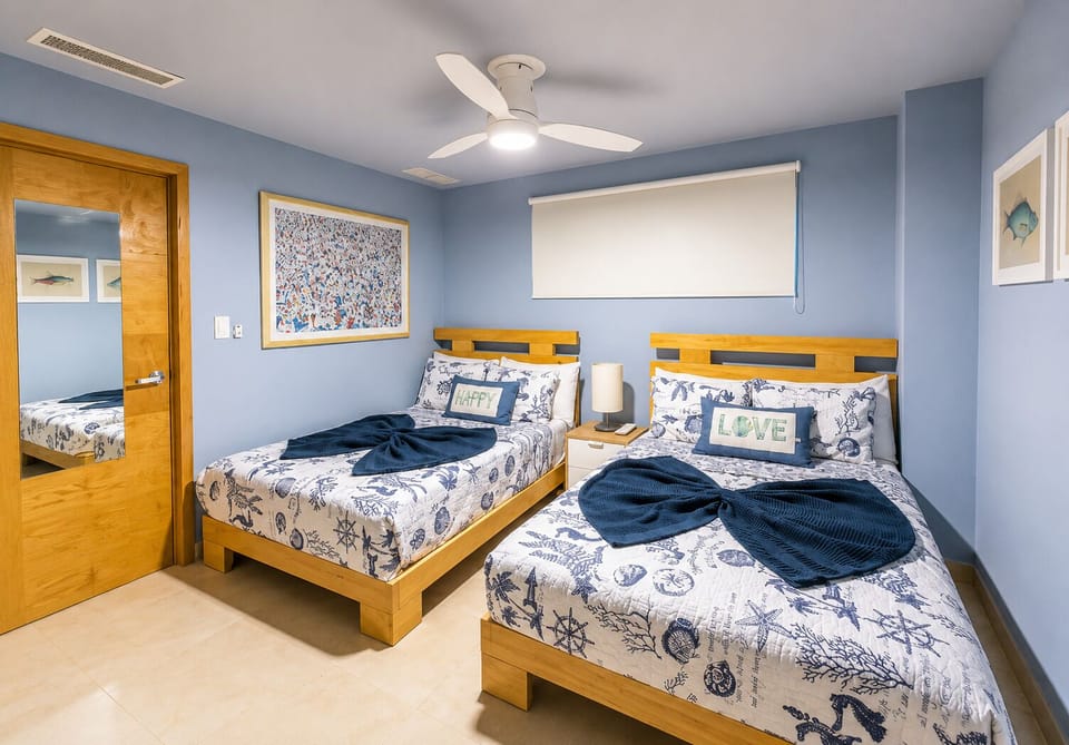 Bedroom #2 features two full-size beds, private bathroom, A/C, ceiling fan, and plenty of space to unwind.