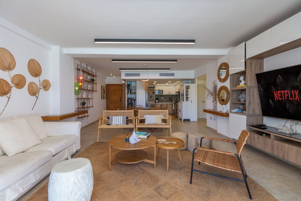 Living room: Bright and spacious, featuring central air and stunning views of the pool and beach.