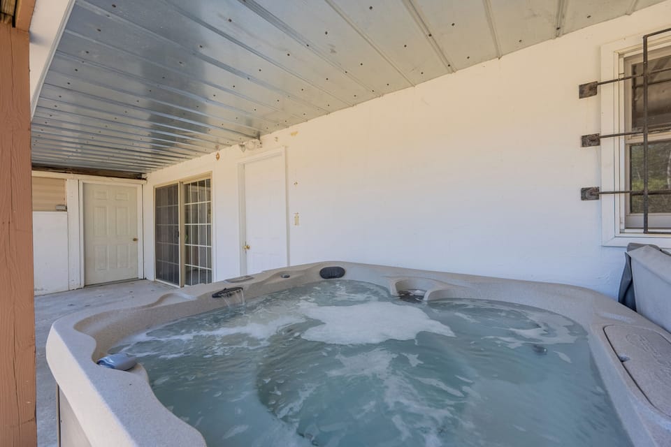 Relax year-round in the private covered hot tub oasis
