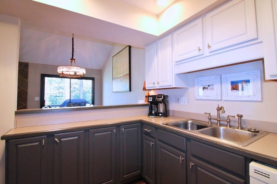 The open kitchen overlooks the dining area, making it easy to cook, serve, and stay connected with your group.