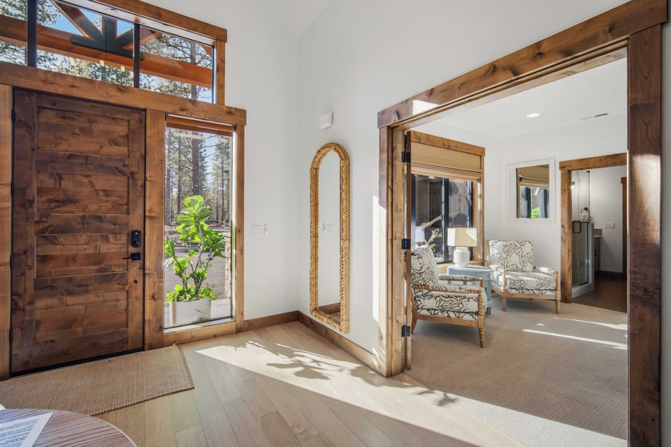 Step into your bright, welcoming entryway where warm wood accents and natural light create the perfect mountain retreat atmosphere.