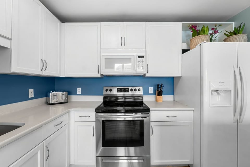 Modern kitchen with stainless steel appliances and white cabinetry