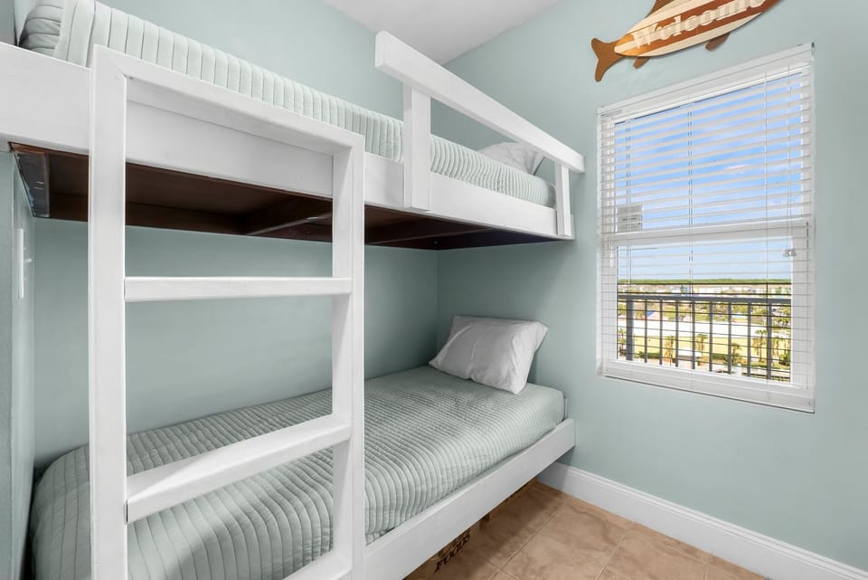 Cozy bunk bed setup with natural light and a view through the window