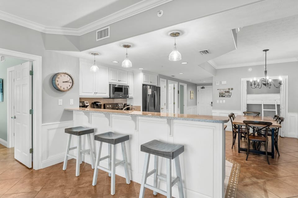 modern kitchen with a breakfast bar and pendant lighting