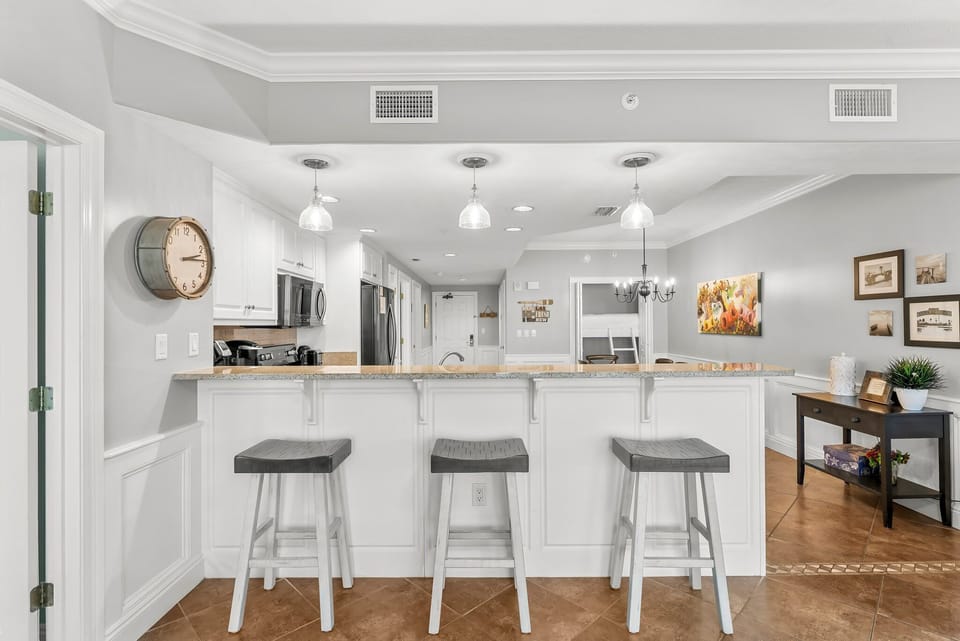 Modern kitchen with a breakfast bar and pendant lighting for casual dining.