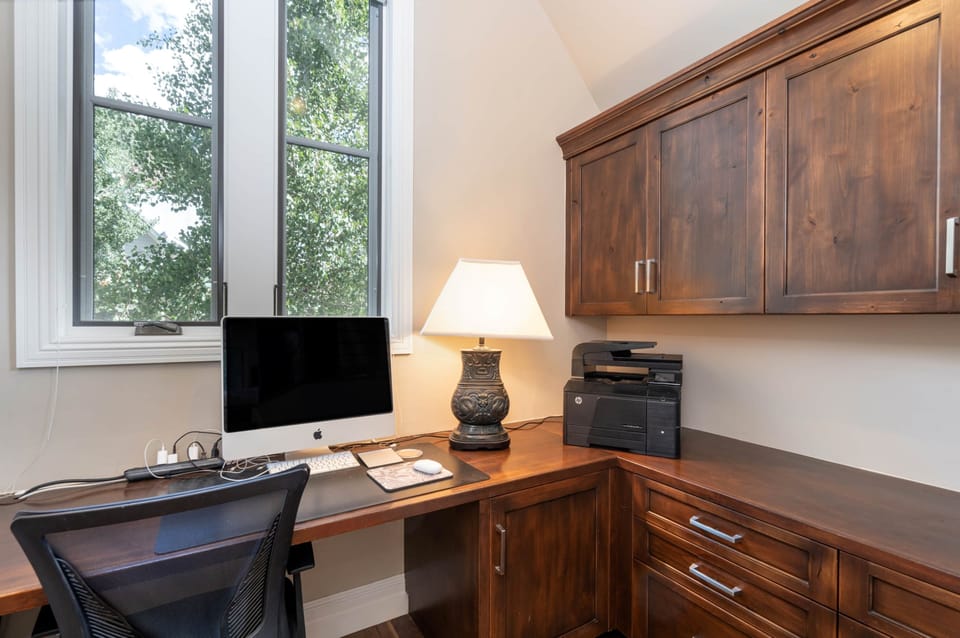 Generously sized office with Apple computer and printer in primary bedroom