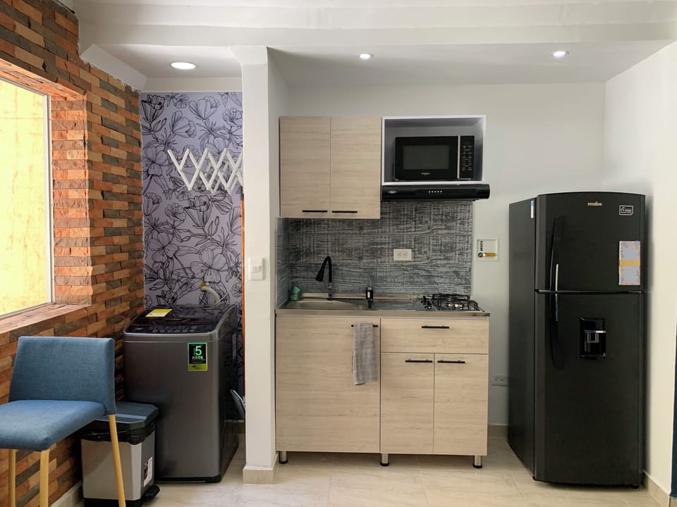 small but mighty kitchen with everything you need: coffee maker, blender, pots 