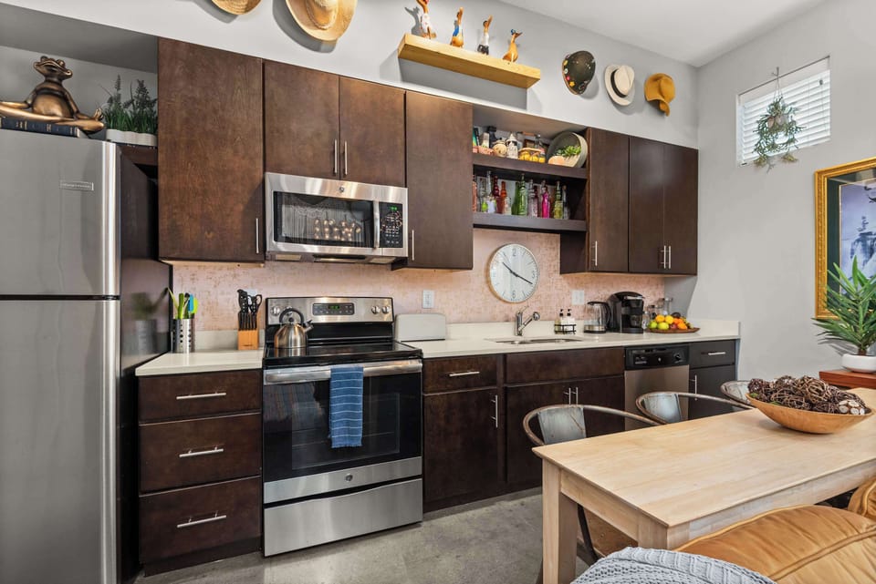 Full kitchen with stainless appliances and breakfast bar seating