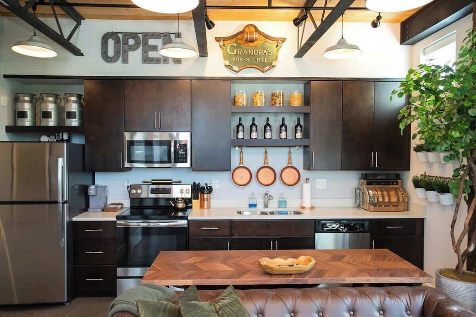 Kitchen with exposed brick and a vintage OPEN sign