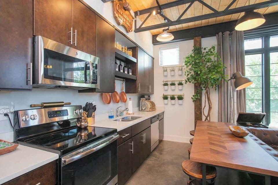 Kitchen with dark cabinetry and stainless appliances