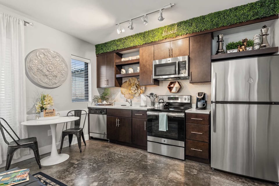 Kitchen with green cabinetry and full-size appliances