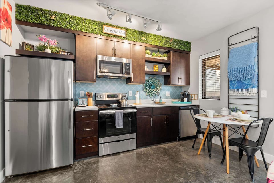 Kitchen with stainless appliances and dining table