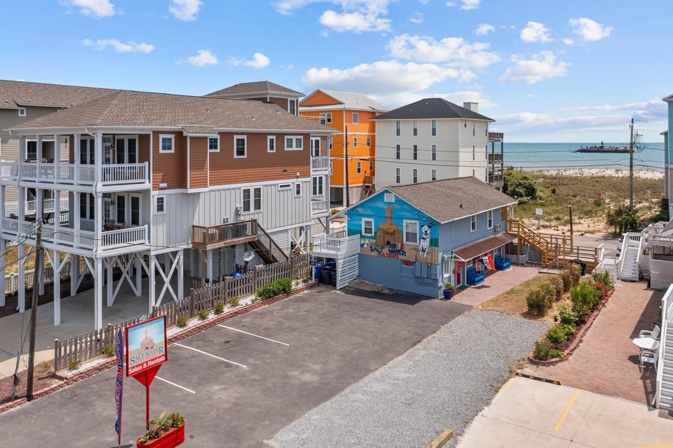 Colorful beachfront rental homes with direct ocean access and convenient parking create the perfect coastal getaway destination.