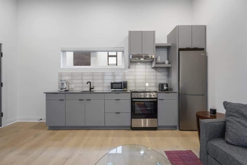 A fully equipped kitchen is included within the open space, offering convenience for cooking.