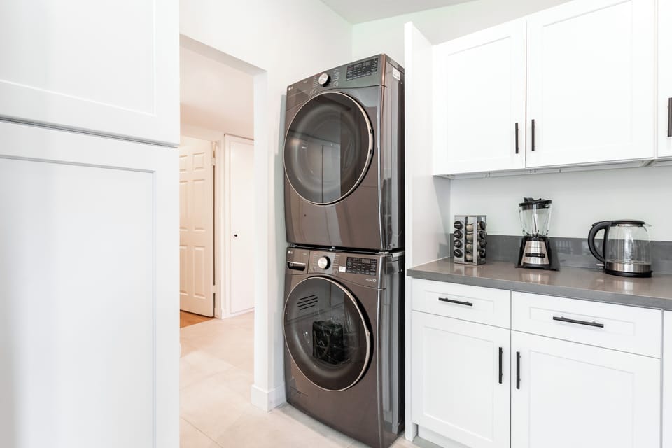 In-unit stacked washer and dryer for convenient long or mid stays