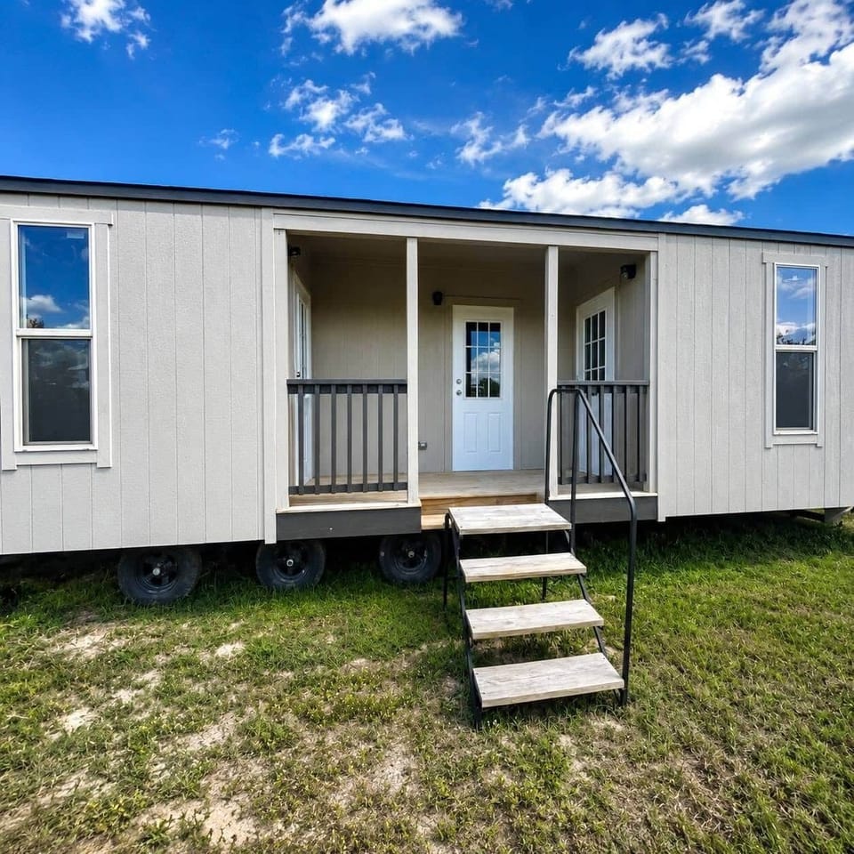 Exterior of Tiny Home - Each Side is a Hotel Style Room - Center Door is Laundry Separating the Room