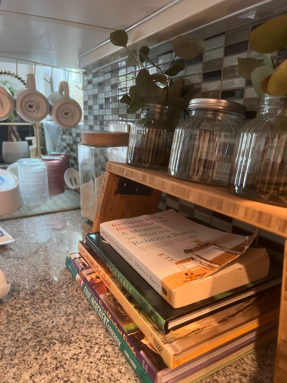Bright, modern kitchen stocked with essentials, cookbooks, and cozy touches.