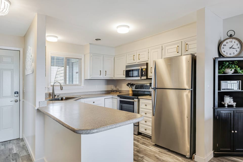 Kitchen with complete appliances spacious countertops for easy meal preparation.