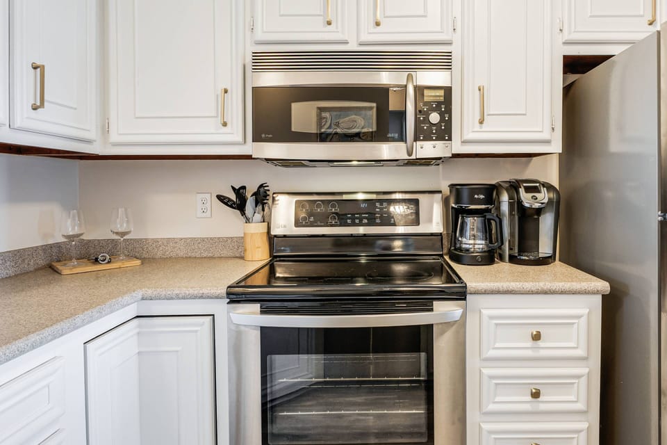 Kitchen featuring modern appliances. Choose from a classic drip coffee maker for a full pot or a single-serve machine for a quick cup.
