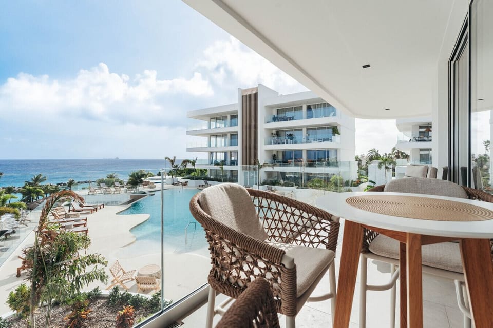 Enjoy breathtaking views and coastal breezes from your expansive private terrace, featuring comfortable lounge seating and a spacious dining area perfect for al fresco meals.