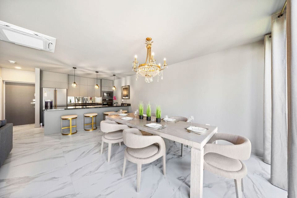 Elegant dining area with a modern kitchen nearby—perfect for shared meals and easy entertaining.