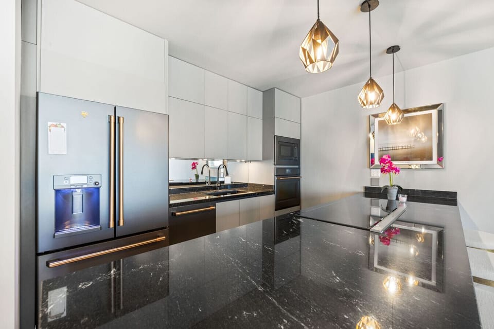 A sleek, fully equipped kitchen with modern appliances and plenty of space—perfect for cooking, dining, or simply enjoying a quiet morning.
