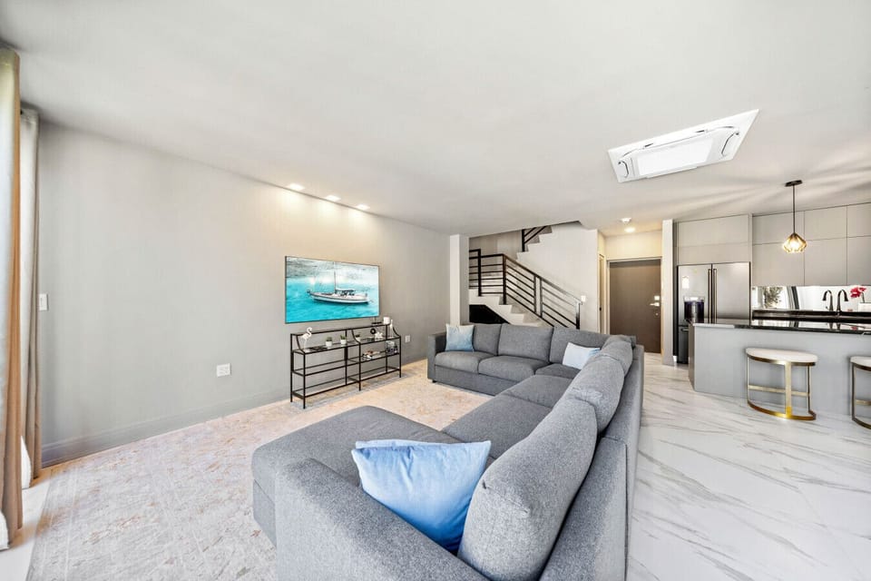A bright, open living space with a comfy sectional—perfect for relaxing, streaming a movie, or spending time together.