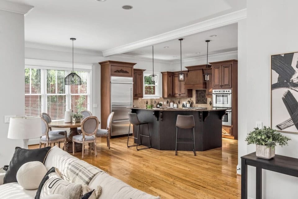 Chef's kitchen with a gas range, double ovens, high-end fridge/freezer, and plenty of seating at the counter. Additional kitchen table seating for 5 at the round breakfast table.