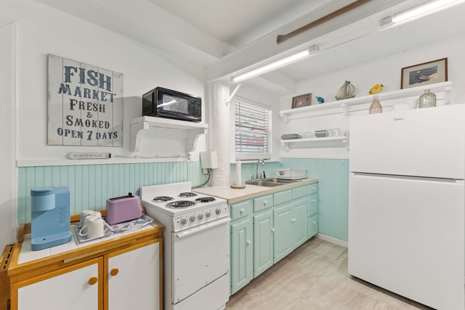 Cook your favorite meals in this charming coastal kitchen with vintage touches and all the essentials you need.