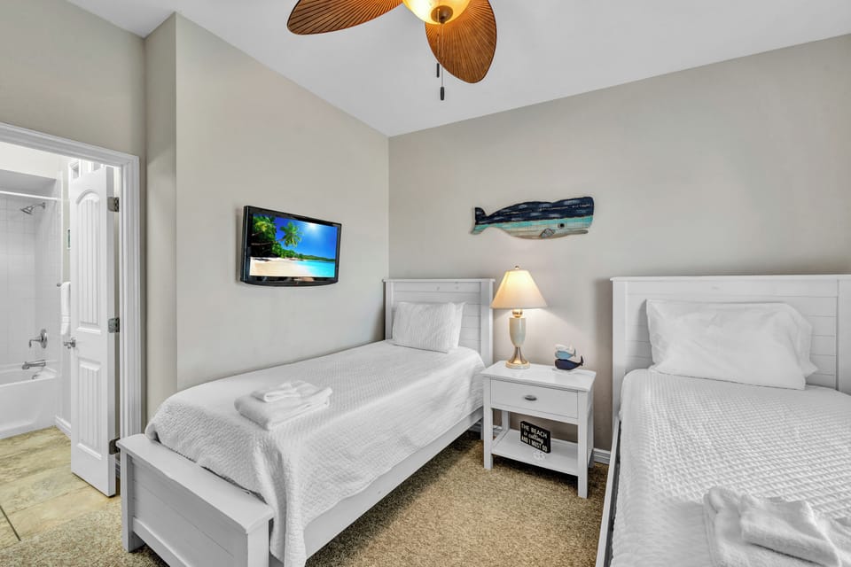 Rest comfortably in your twin bedroom with crisp linens, coastal decor, and entertainment at your fingertips.