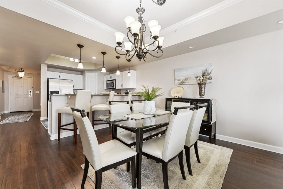 Dining area looking into kitchen. Table for 6. Bar top for 3.
