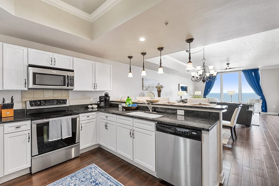 Open floor plan kitchen, dining, living room, balcony.
