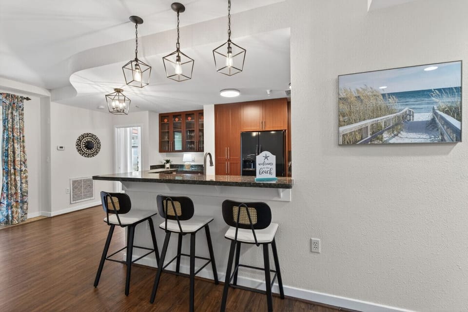 Open kitchen with bar seating so the chef never misses a moment of conversation or vacation fun.