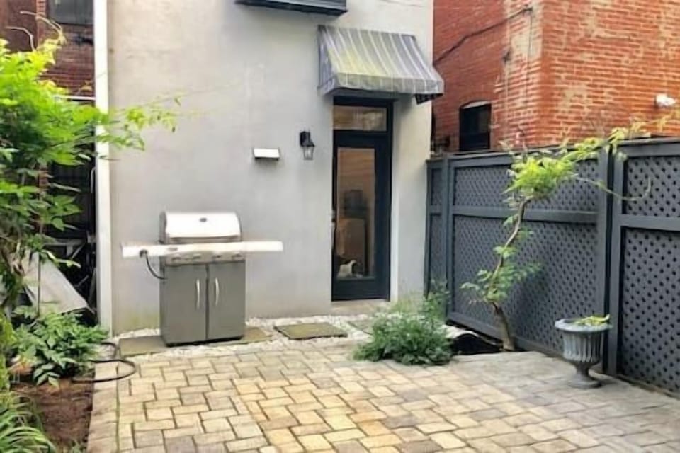 Private fenced patio with a full-size gas grill—perfect for outdoor meals, quiet mornings, or evening hangs.