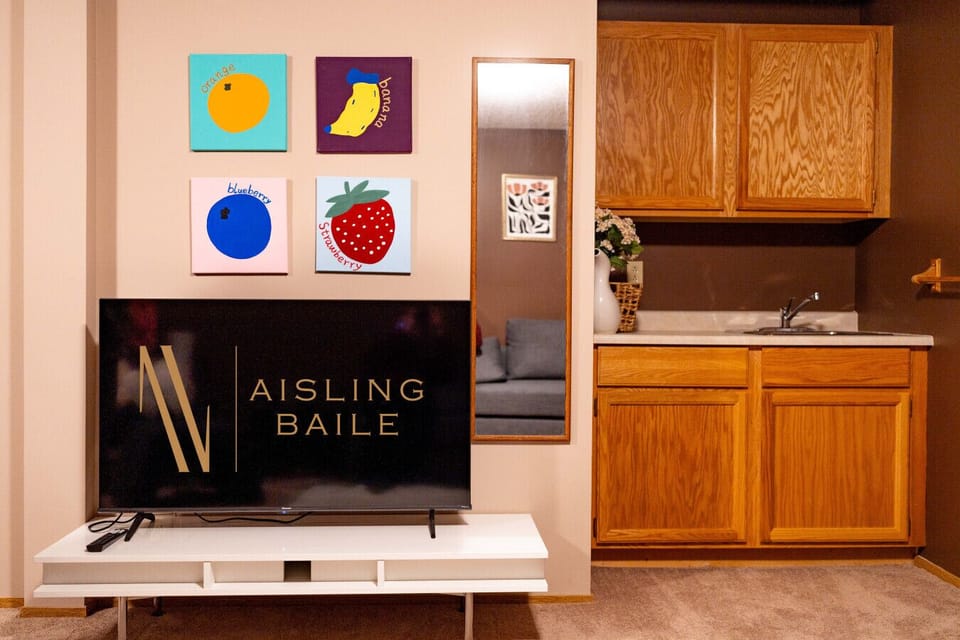 The downstairs game room features a smart TV, air hockey table, wet bar & board games.