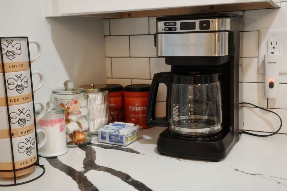 Coffee grounds, filter, sugar and creamer are provided.
