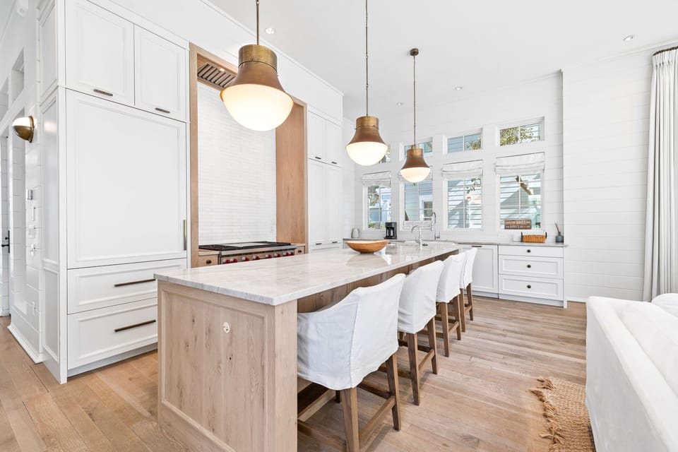 Chef's Kitchen with Natural Lighting, Luxury Island Seating, and Custom Cabinetry