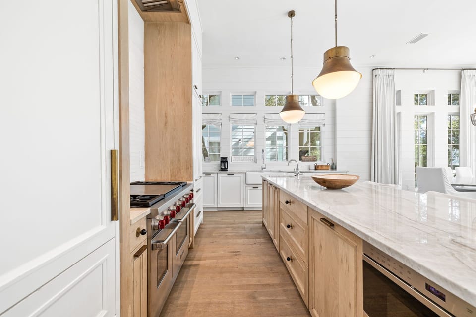 Chef's Kitchen with Natural Lighting, Luxury Island Seating, and Custom Cabinetry