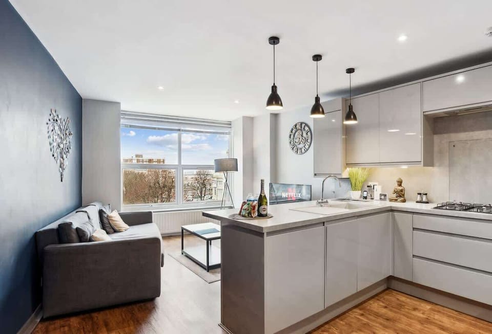 Modern, fully equipped kitchen with a clean, neutral design. Includes oven, hob, fridge-freezer, microwave, kettle, toaster, dishwasher, and all essentials for easy self-catering.
