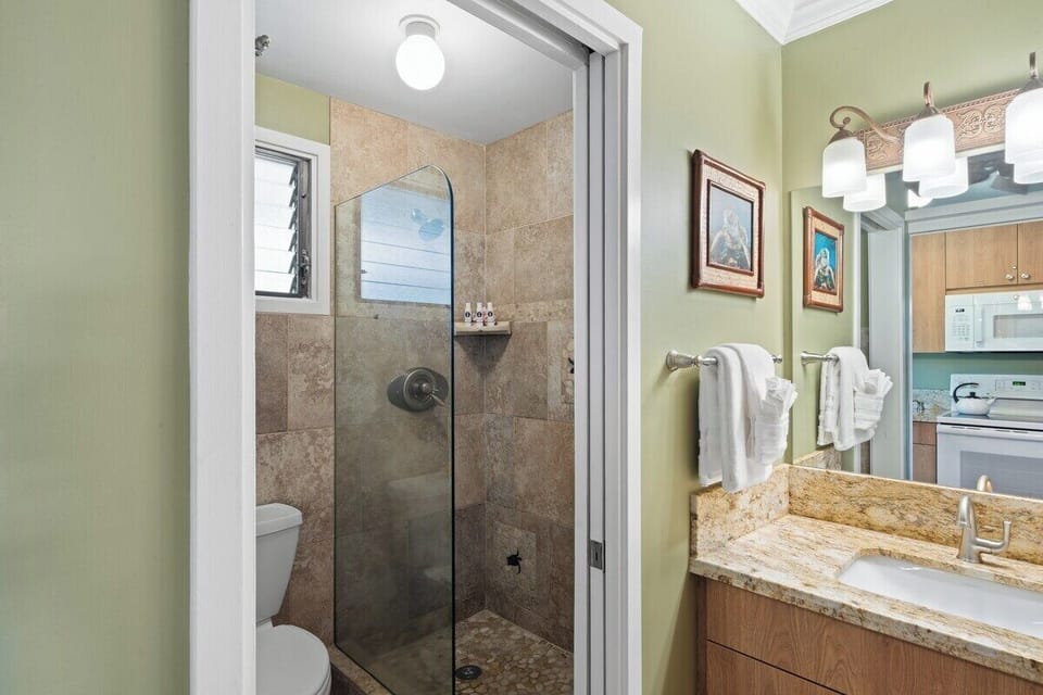Updated bathroom with a large tiled shower and simple, clean finishes throughout.